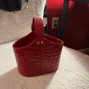 Small leather red purse bag with buckle, handle, and gold finishing